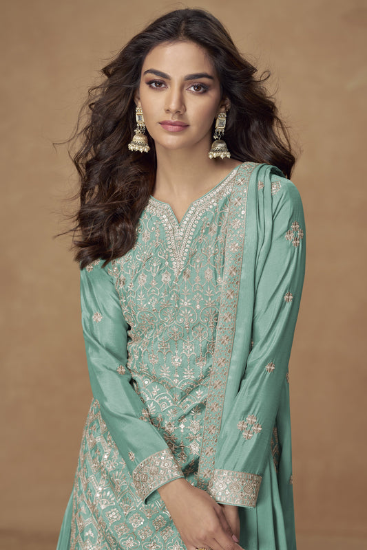 Turquoise blue color palazzo suit in Chinon fabric with embroidery work, offering a vibrant and refreshing look perfect for festive gatherings.