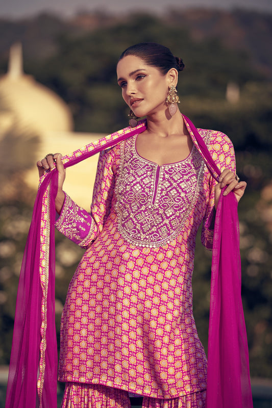 Baby pink color palazzo suit in premium Chinon silk fabric with fine embroidery work, perfect for a subtle yet stylish festive appearance.