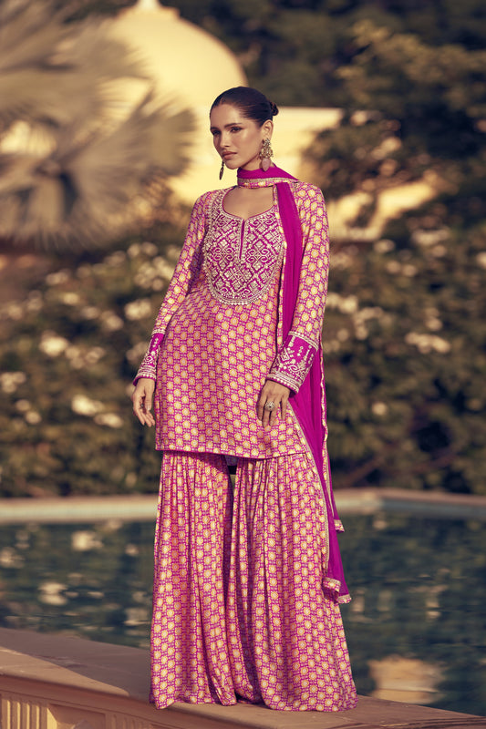 Baby pink color palazzo suit in premium Chinon silk fabric with fine embroidery work, perfect for a subtle yet stylish festive appearance.
