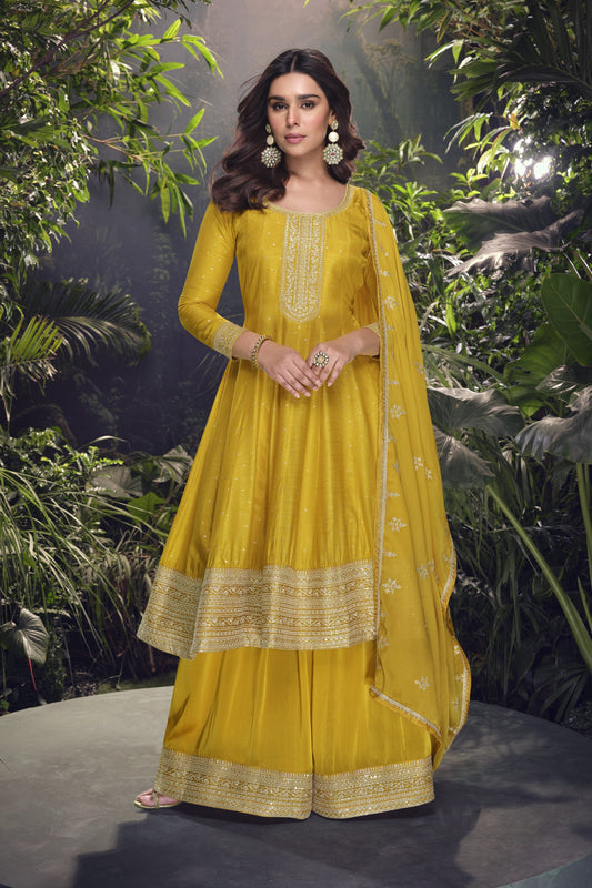 Yellow color palazzo suit in viscose jacquard silk fabric with embroidery work, radiating vibrant elegance perfect for festive and special occasions.