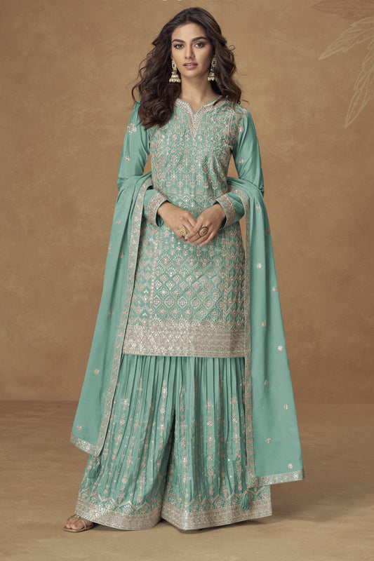 Turquoise blue color palazzo suit in Chinon fabric with embroidery work, offering a vibrant and refreshing look perfect for festive gatherings.