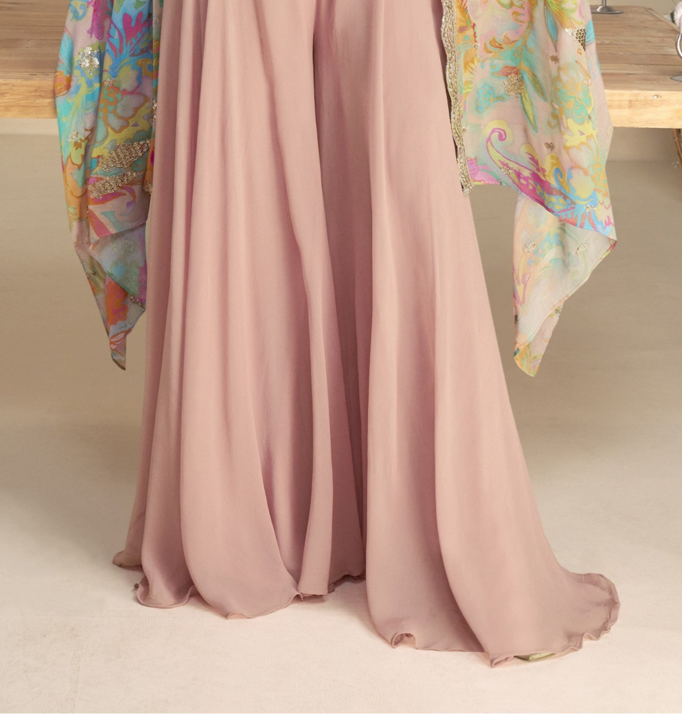 Light pink color shrug lehenga in premium Chinon silk with heavy embroidery and hand embellished work, perfect for a graceful and festive appearance.