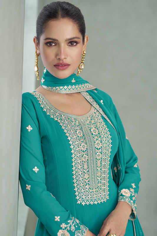 Teal blue color Anarkali gown in georgette fabric with sequin and embroidery work, blending vibrant sophistication with festive appeal.
