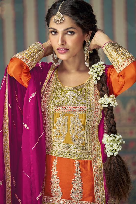 Orange color palazzo suit in Chinon silk fabric with embroidery work, showcasing vibrant elegance perfect for festive celebrations and traditional gatherings.
