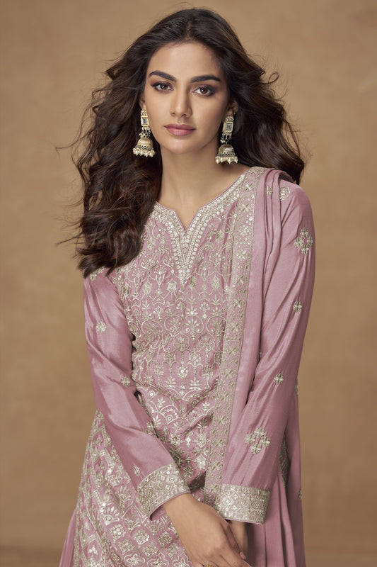 Rose gold color palazzo suit in Chinon fabric with embroidery work, combining soft shimmer with intricate detailing for a graceful festive appearance.
