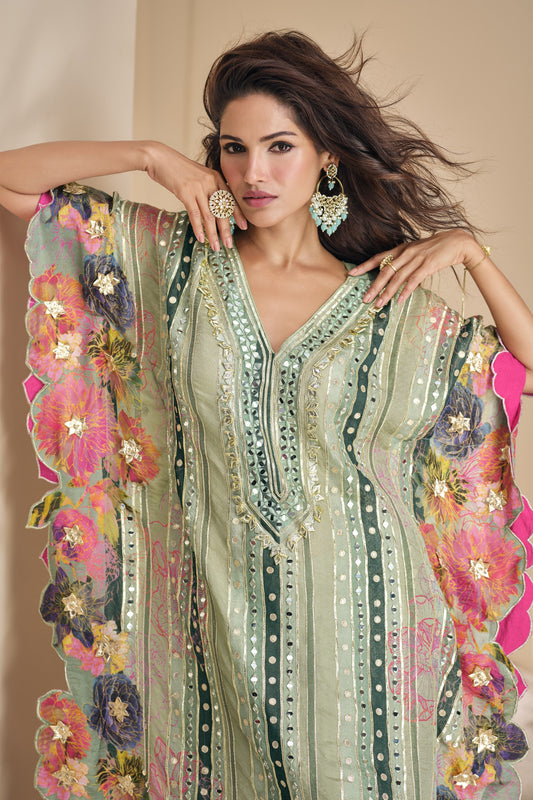 Light green color palazzo suit in viscose silk fabric with shimmering mirror and embellished accents, offering a fresh and graceful appearance for special occasions.


