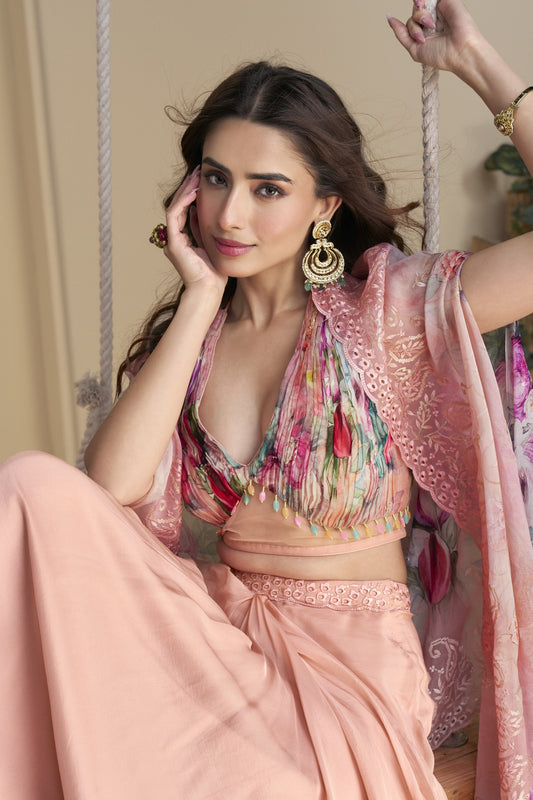 Peach color shrug lehenga in premium Chinon silk with heavy embroidery and hand embellished work, offering a soft and elegant style for festive and special occasions.
