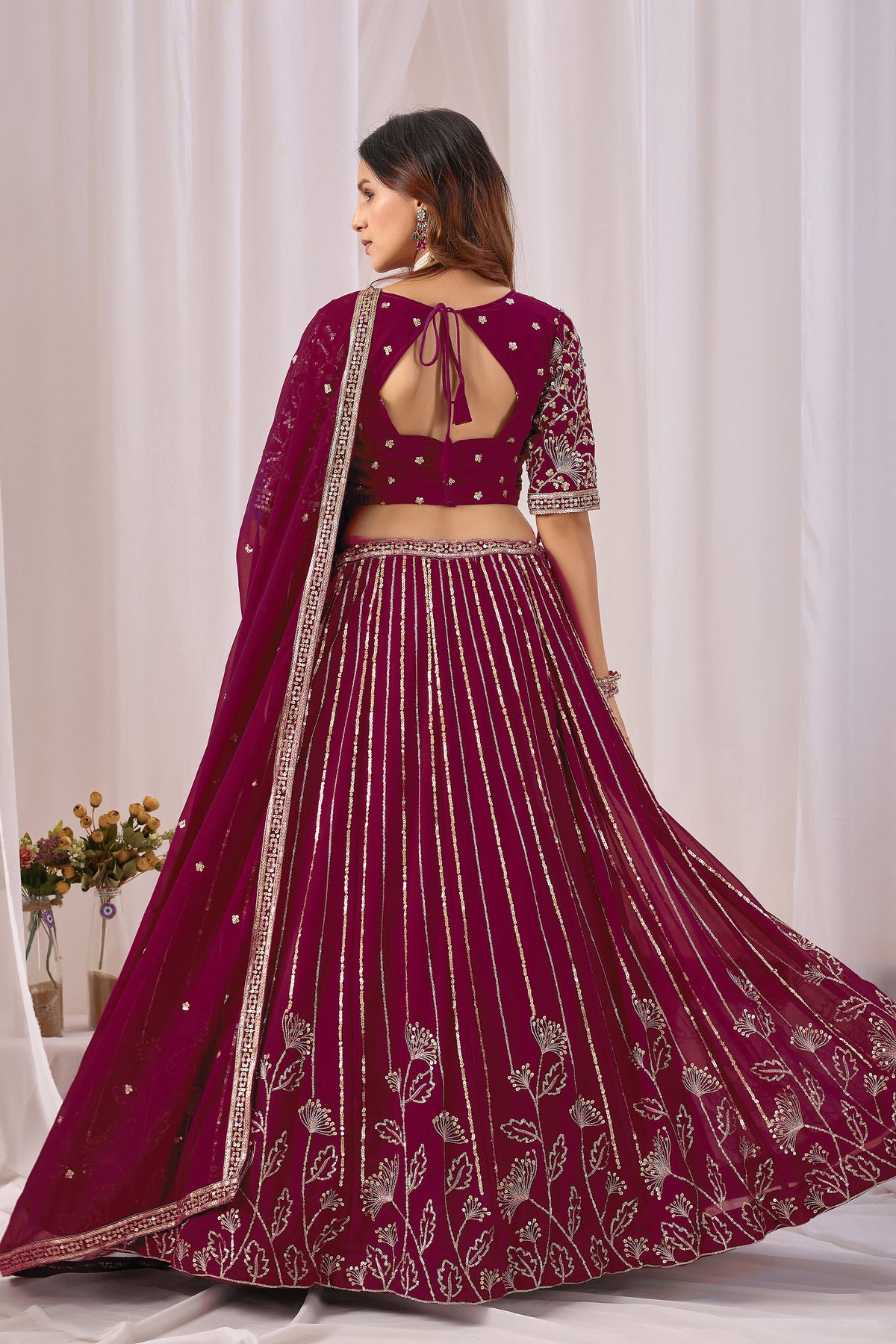 Back view of the burgundy red lehenga choli blouse, if shown