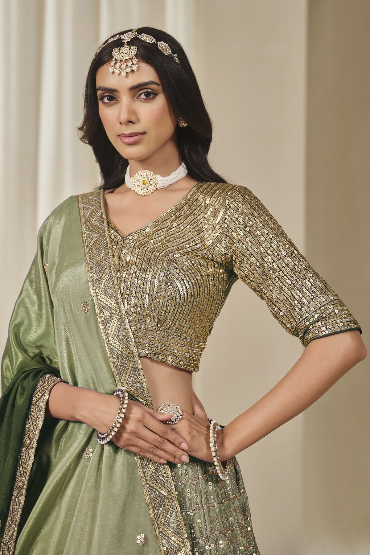Green lehenga and choli with detailed embroidered skirt