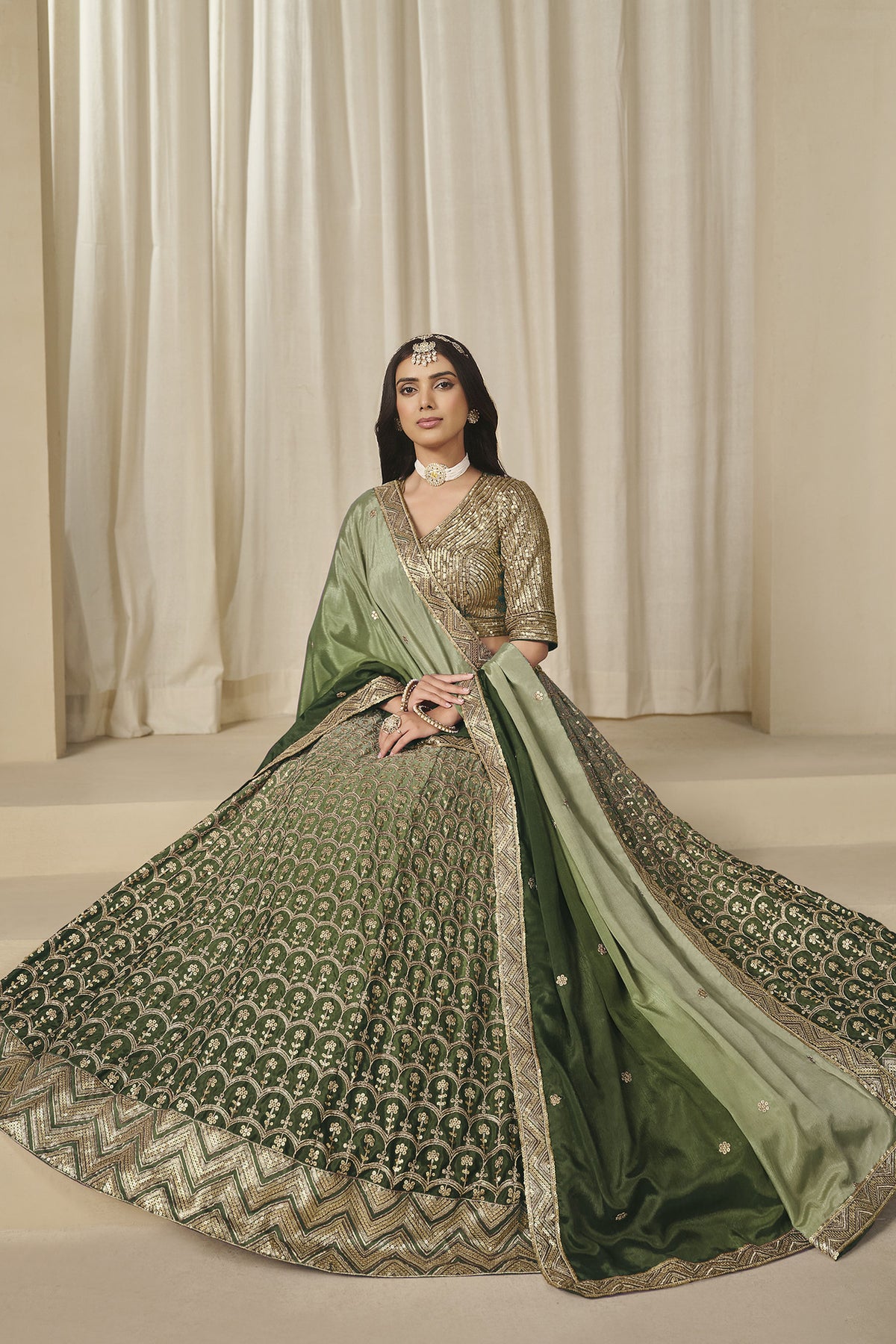 Green lehenga skirt with all-over embroidery and geometric hem border