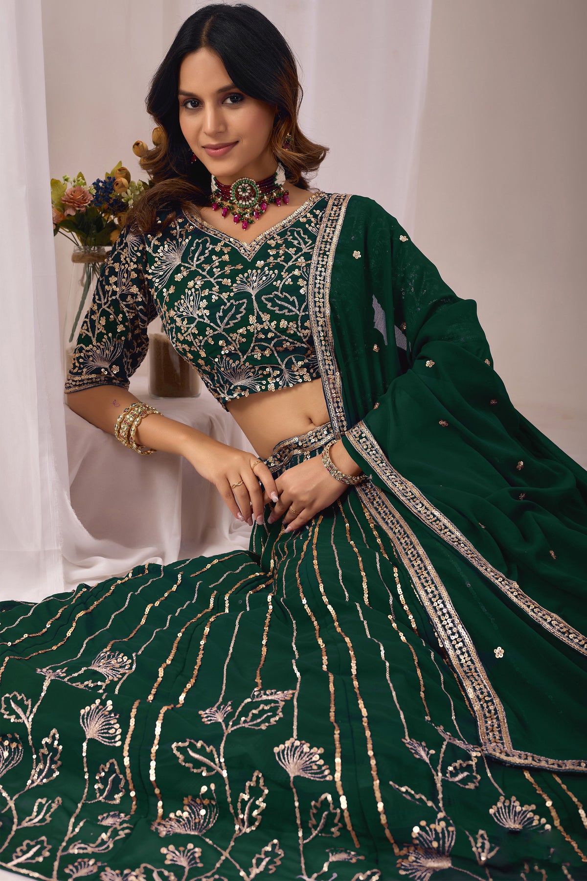 Close-up of embroidery and sequin work on the green lehenga.