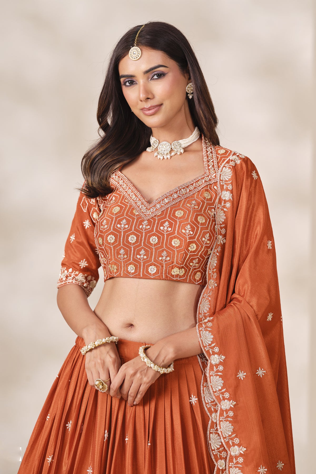 Orange lehengha choli suit for festive and wedding occasions.