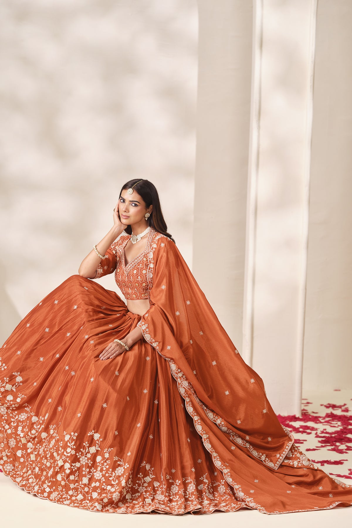 Front view of the orange lehenga choli with matching dupatta.