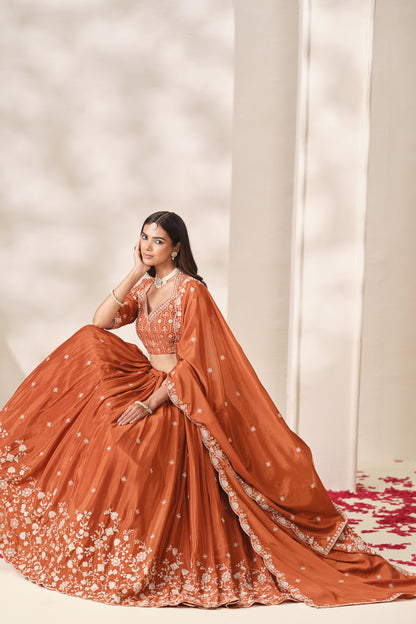Front view of the orange lehenga choli with matching dupatta.