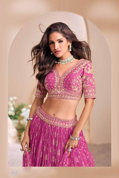 Designer pink lehenga choli with detailed golden zari embroidery on yoke and sleeves, fitted, cropped blouse for festive occasions
