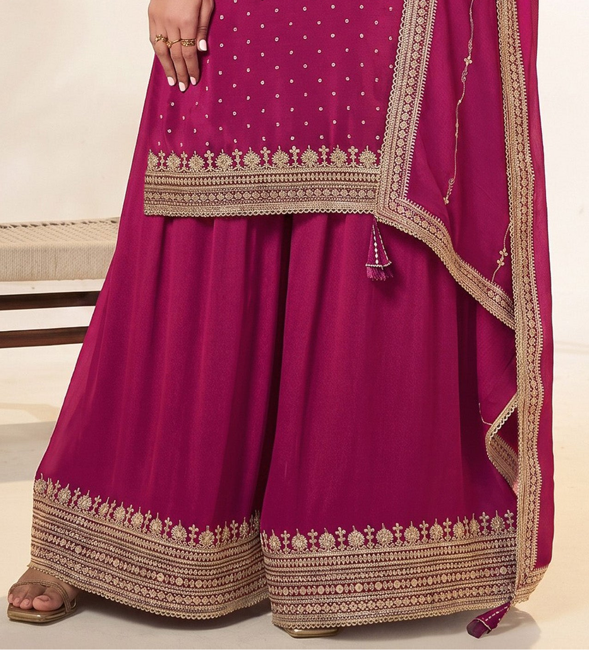 Bottom view of pink stitched dress with embroidered hemline