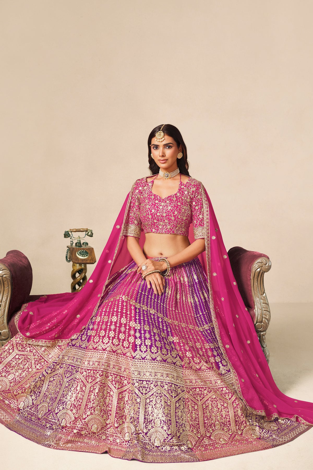 Close-up of heavy embroidery on the pink lehenga