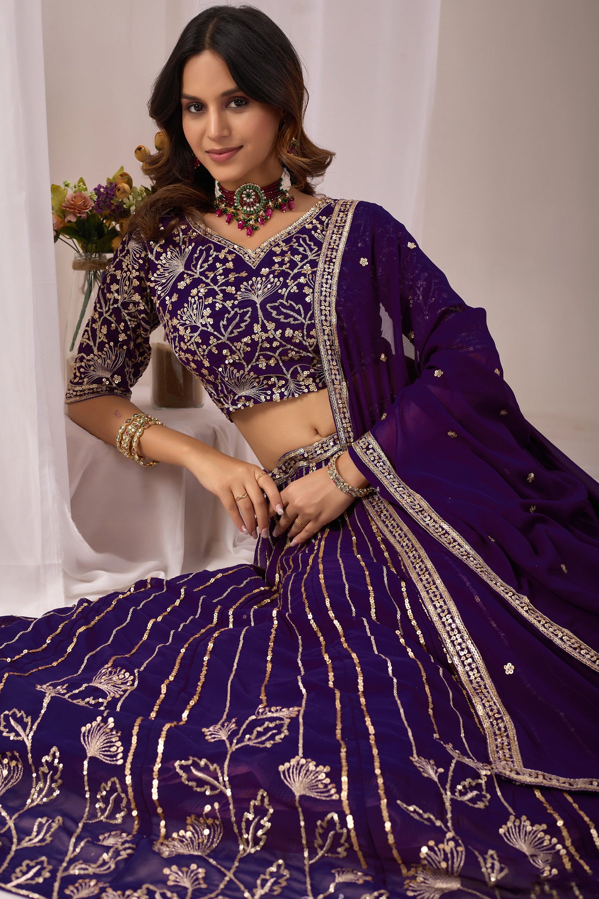 Close-up of embroidery work on the purple lehenga