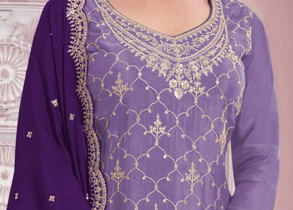 A close-up of a purple traditional outfit with intricate gold embroidery on the neckline and across the fabric, paired with a matching purple dupatta draped over the shoulder.
