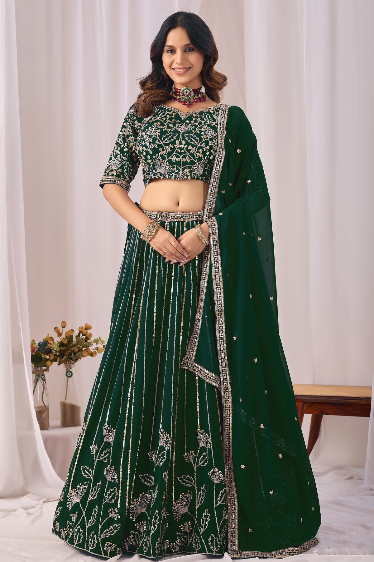 Royal green lehengha choli with heavy embroidery and sequin work, front view.