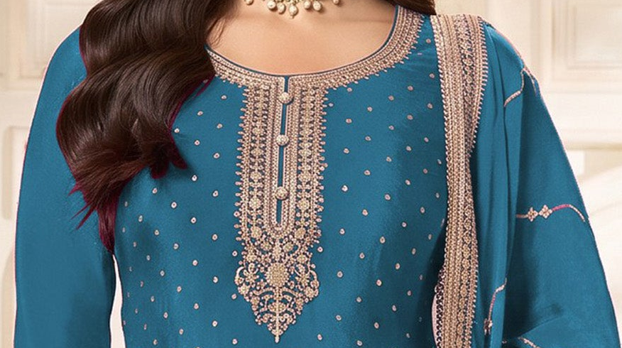Close-up of sequence and coding work on sky blue neckline