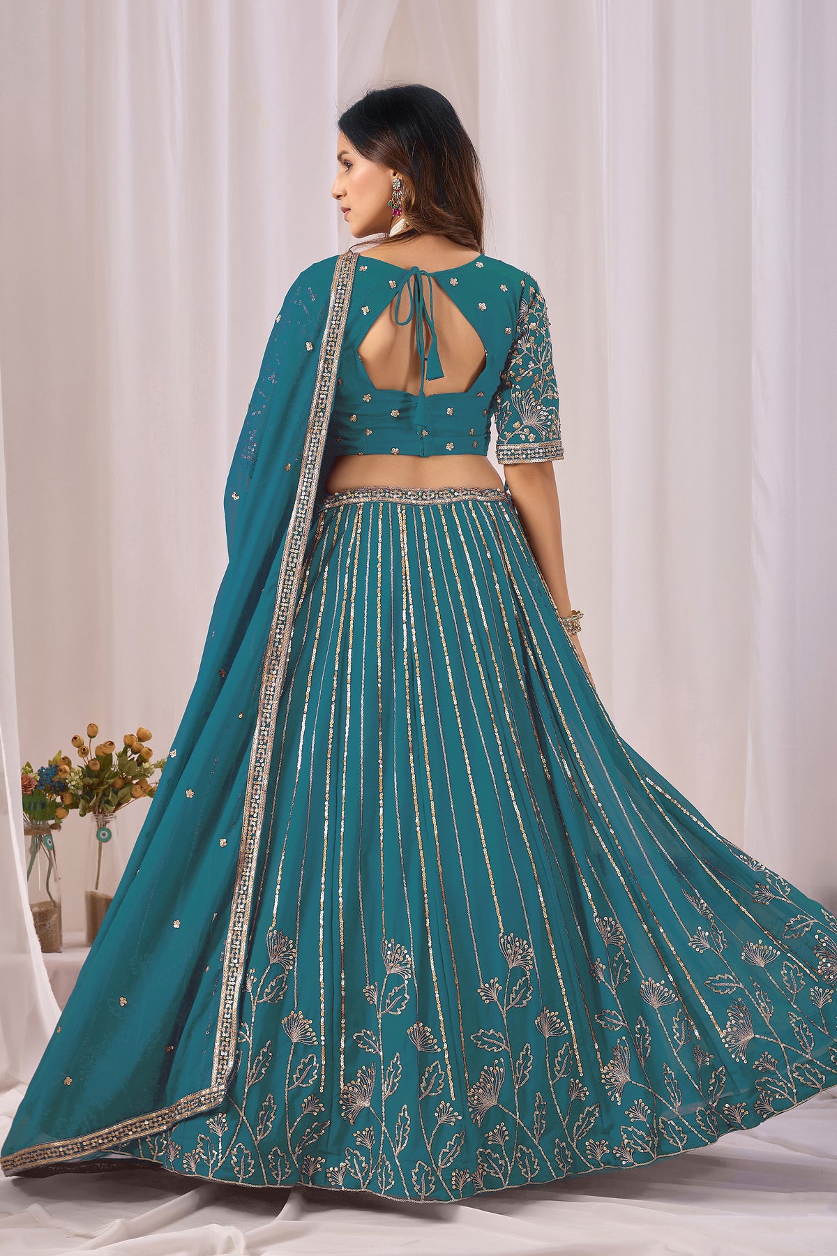 Back view of the teal blue blouse, if shown.