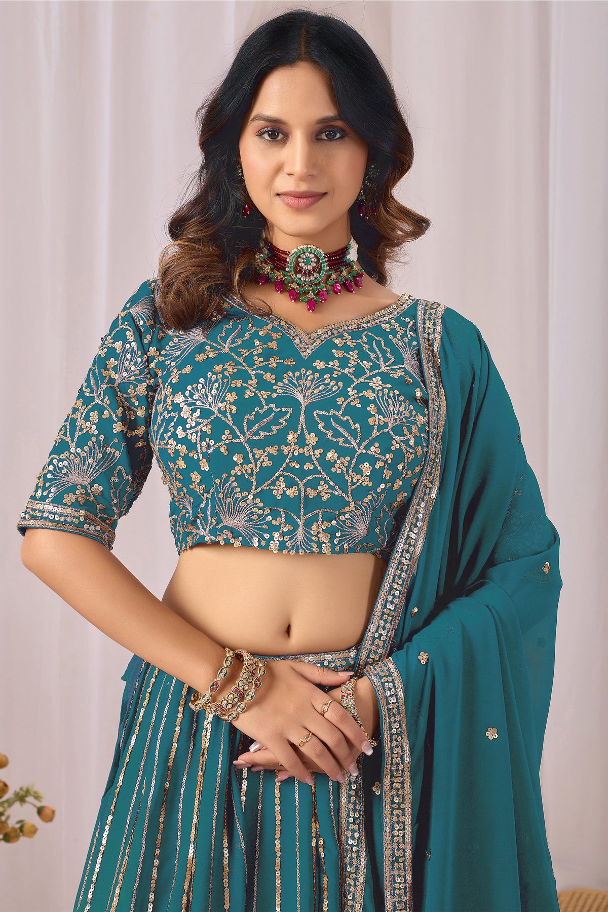 Front view of a teal blue lehenga choli outfit.